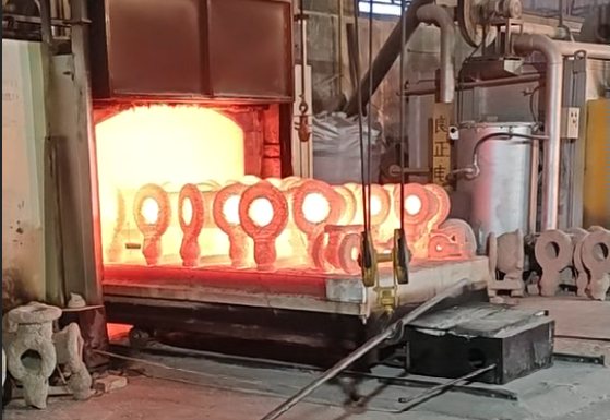 Valve castings coming out of the heat-treatment furnace at the BAUTU foundry